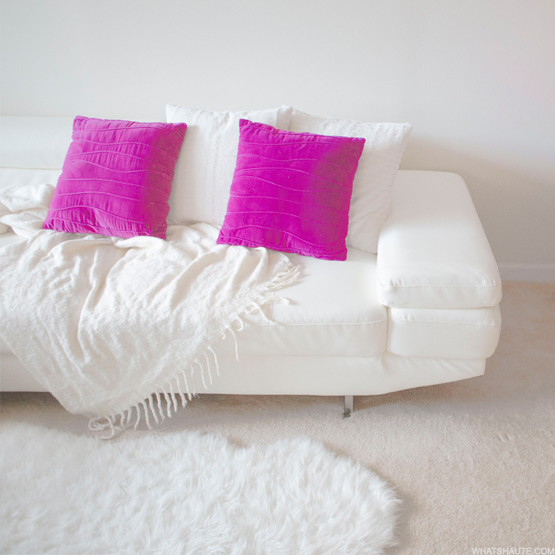 Home: White leather couch with purple pillows